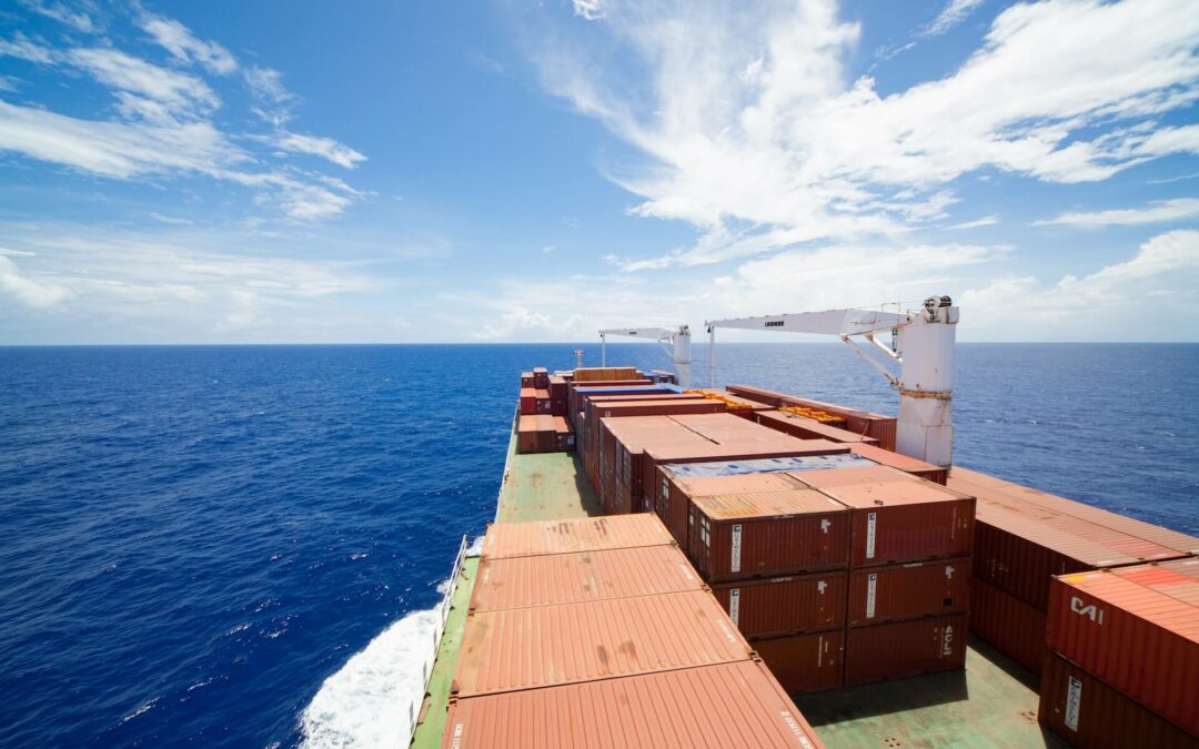 Red TEU containers stacked on a ship traveling the Atlantic Ocean