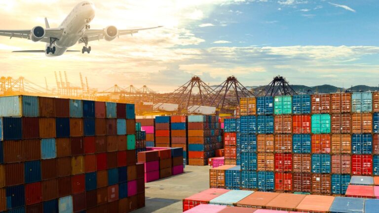 Airplane flying over stacks of colorful shipping containers at a busy cargo port with cranes in the background, representing global trade, logistics, and international supply chains.