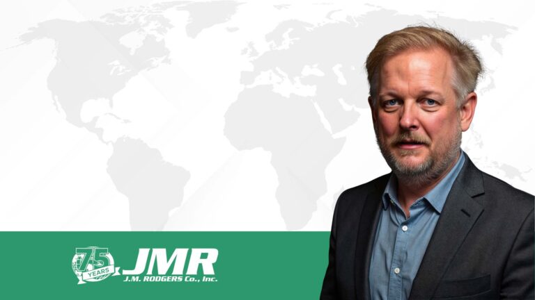 JMR's CEO, James Rodgers, in front of a global trade map.