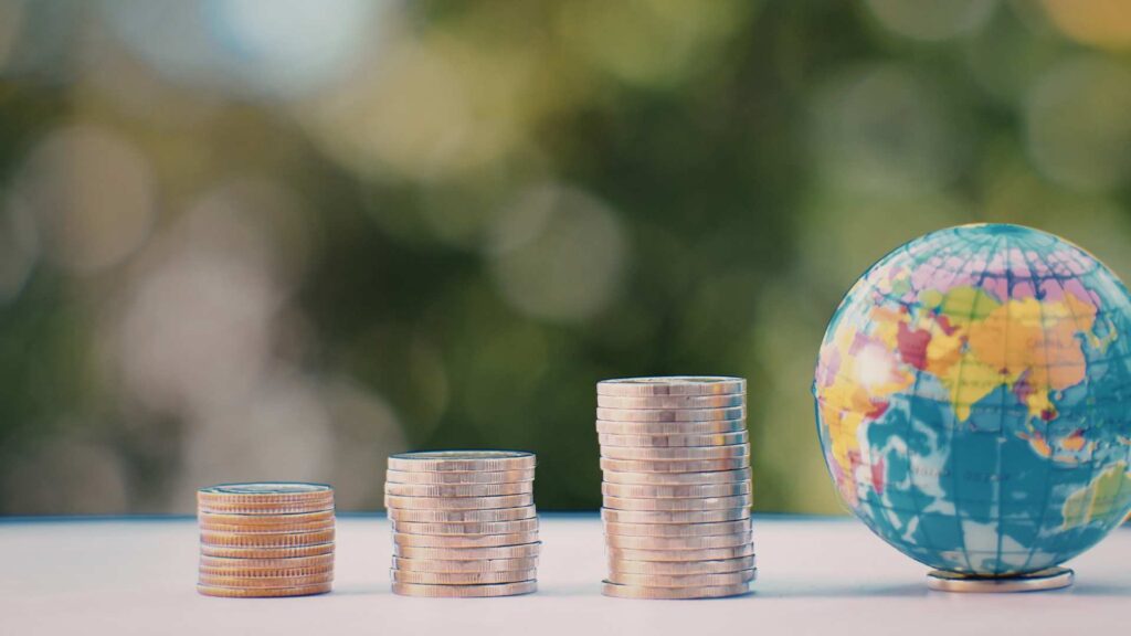 Globe sitting next to coins representing section 301 tariffs and global trade.